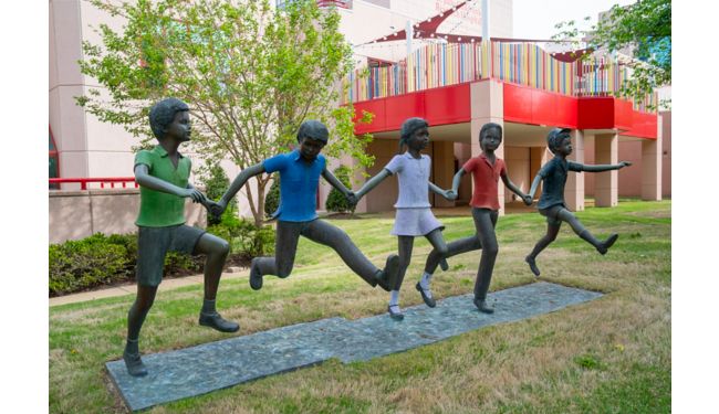 A statue of children running and holding hands