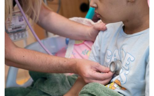 image of someone using a stethoscope to listen to a child's chest