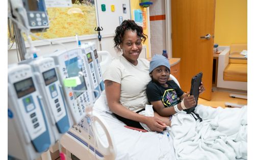 image of woman sitting in hospital bed with patient