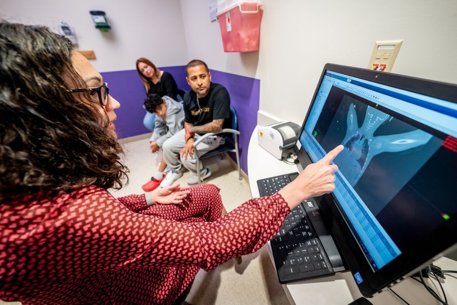 radiation oncology tech showing imaging to patient family