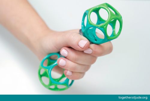 Person holding a toy rattle