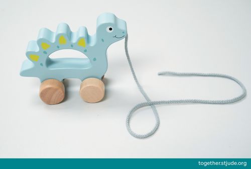 A push/pull toy shaped like a dinosaur