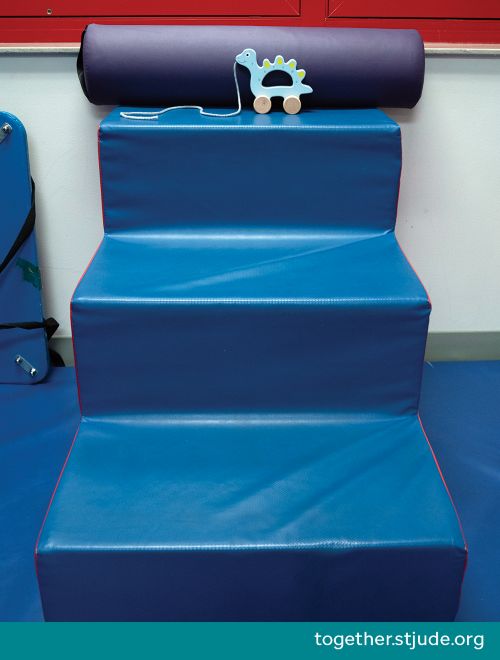 A push/pull toy at the top of a set of small foam stairs