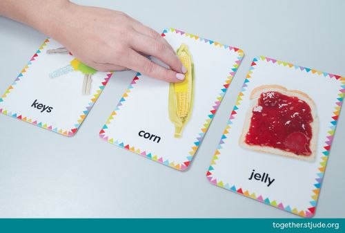 Person touching a picture card of corn