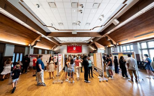 students looking at postes in a hall