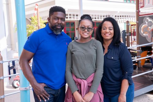 Nia and her parents at Domino's Village 