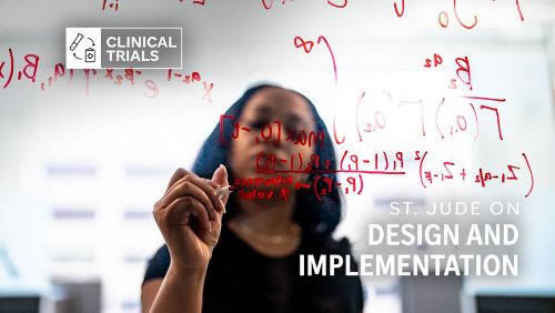Woman drawing scientific formula on glass