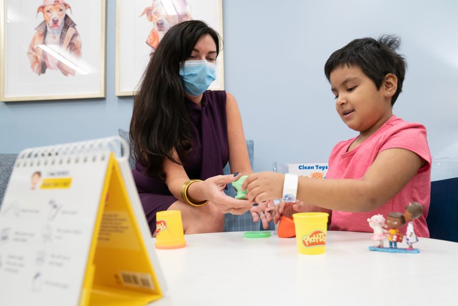 Psychologist playing with female child patient