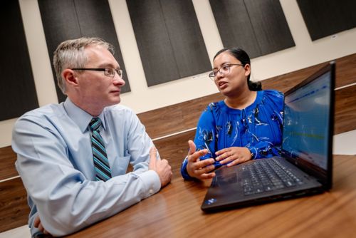 A man and woman sitting at a table talking