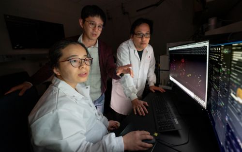 Three people looking at a computer screen