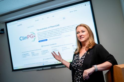 Kelly Caudle in front of a presentation screen