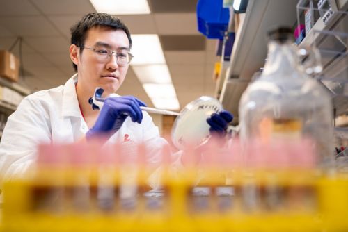 man in white coat working in lab