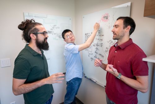 Three men and a whiteboard
