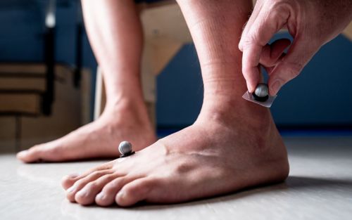 two human feet with sensors