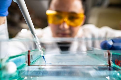 Woman injecting gel in lab