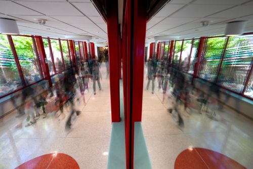 hallway full of people in blurry image