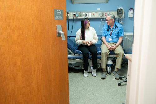 Thanaydi Sandoval speaking with her doctor in clinic setting