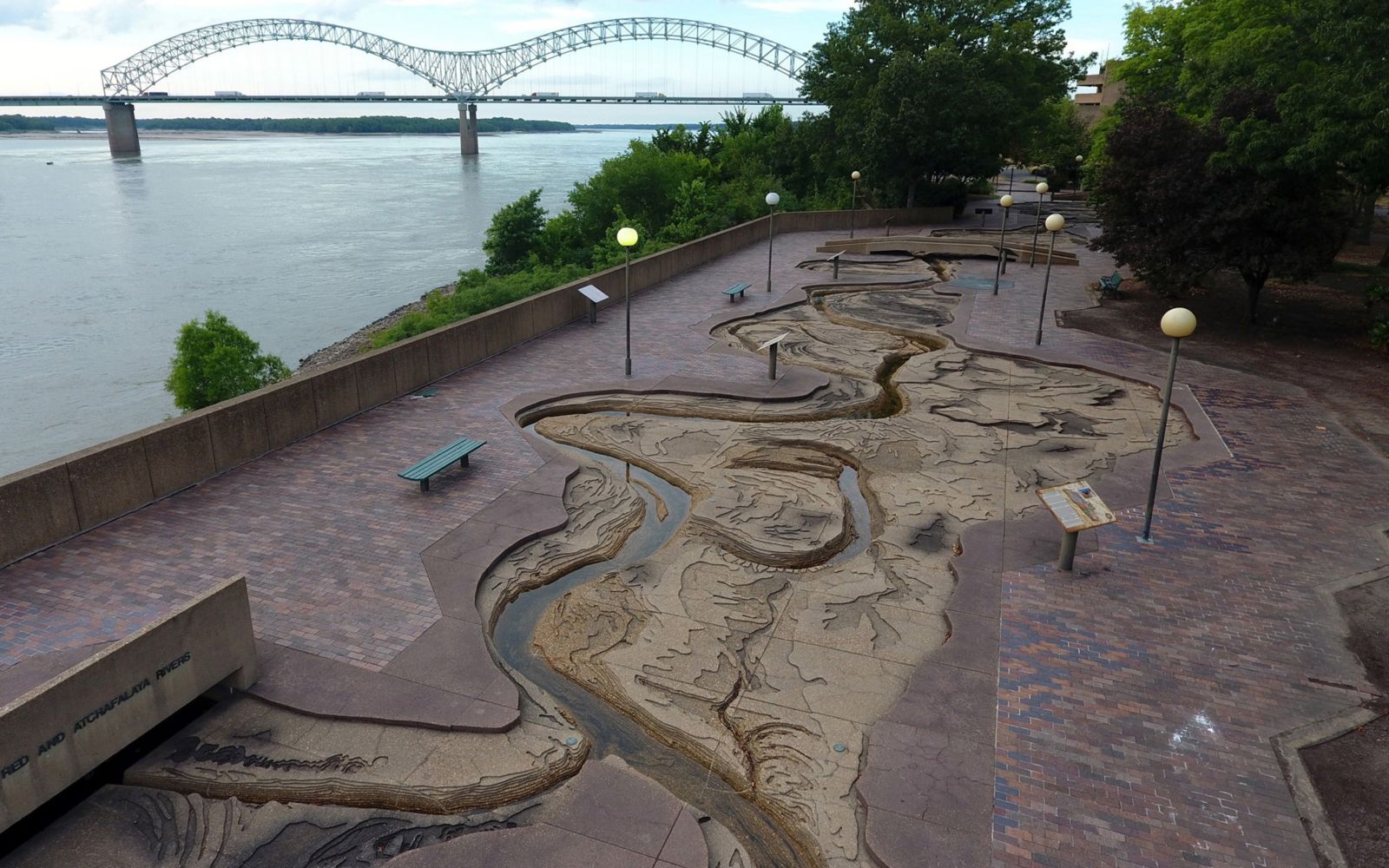 Aerial view of the Riverwalk, a scale model of the Mississippi River, with a view of the Mississippi River and the Hernando De Soto Bridge.