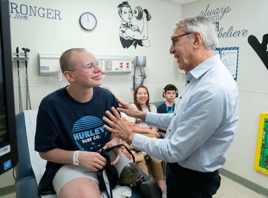 Young adult male patient speaking with doctor in hospital setting