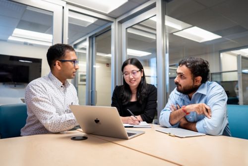 Three people sitting at a table
