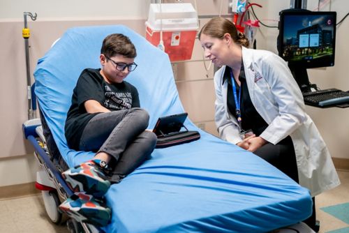 Boy and doctor in exam room