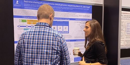 Photo of man and woman looking at research poster