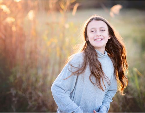 Image of child running through field