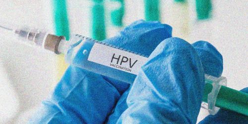 Illustration of gloved hand holding syringe of HPV vaccination