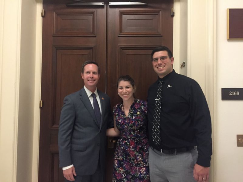 Three people standing in front of door
