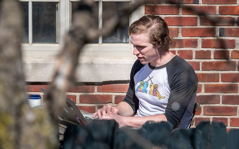 Man in casual clothes reading outdoors