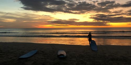 image of surfer at sunset