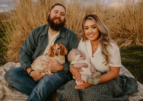 Billy and Stevee Fazenbaker family portrait with Fletcher, and their dog, Hank.