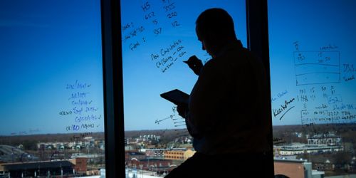 Image of Richard Webby, PhD, making notes on a window