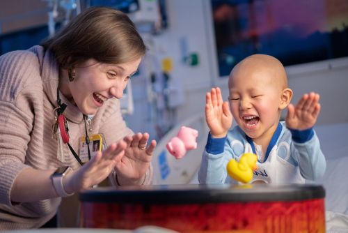 Patient and employee playing with toys and laughing