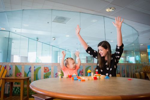 Patient and employee playing with blocks on a table