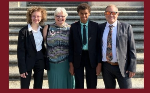 four people standing in front of some stesp