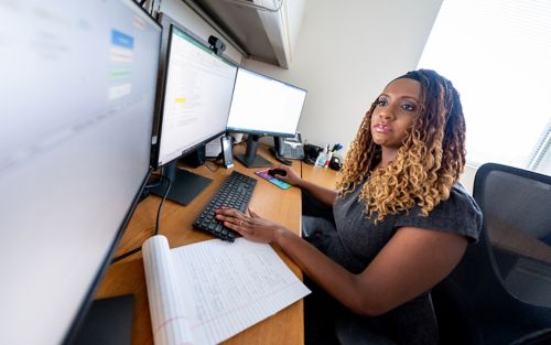 Cancer survivorship researcher at computer