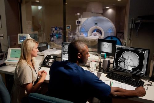 Group photo of St. Jude MRI lab technicians looking at results