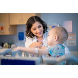 Dr. Asya Agulnik with childhood cancer patient, indoors