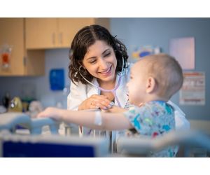 Dr. Asya Agulnik with childhood cancer patient, indoors