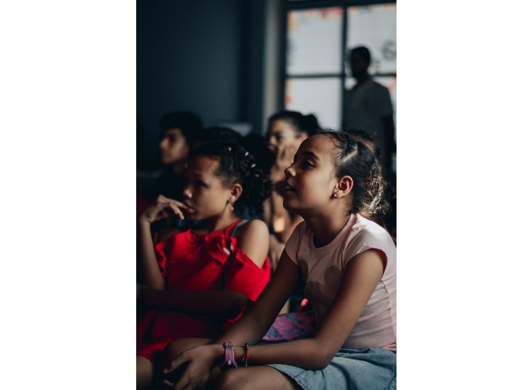 Close up of children watching a performance.