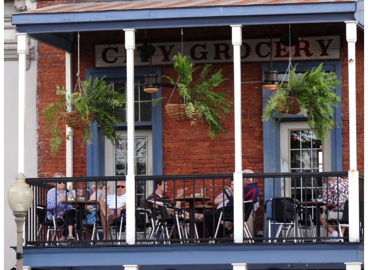 photo of people eating a meal on balcony