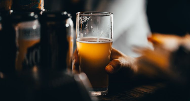 Image of a beer glass held by someone