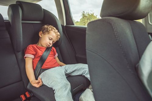 photo of child in red shirt sleeping