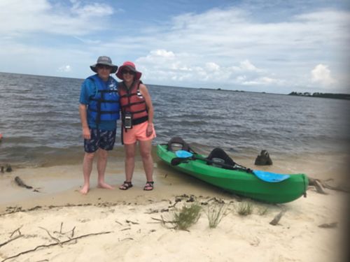 Billy and his wife at the beach with a kayak