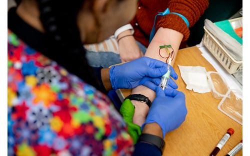 Lab tech conducting blood draw from patient