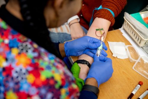For children with cancer, regular complete blood count tests help the care team monitor the patient’s health and ability to fight off infections. In this image, a nurse draws blood by inserting a needle into a vein and collecting the blood in attached vials.  