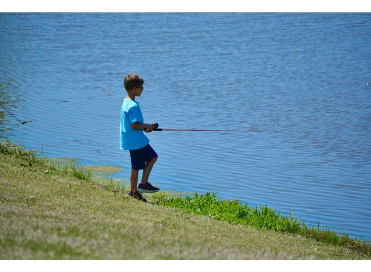 boy fishing in lake