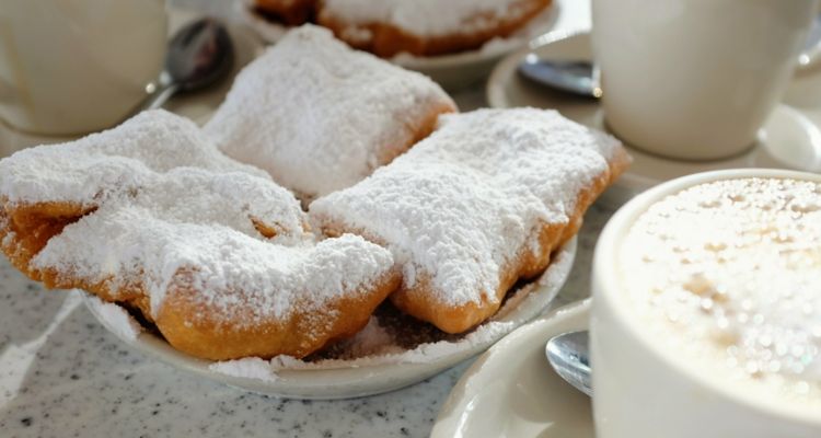 Beignets covered in powdered sugar.
