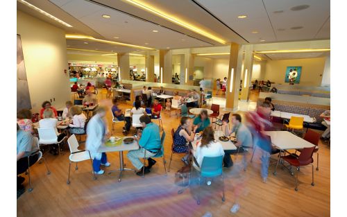 Hospital cafeteria with people dining at tables